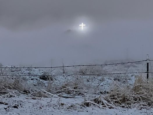 Stunning cross on Tablemount in Idaho shinning through blizzard. 
